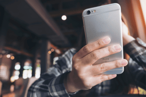 Hand holding phone small